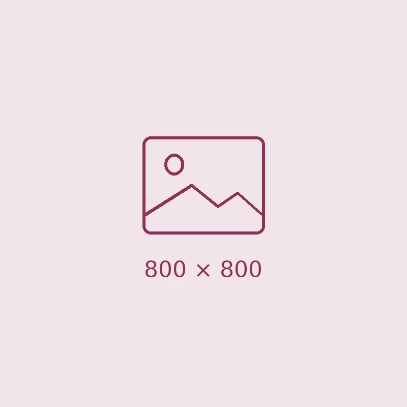 A dental clinician in scrubs and a face mask using suction while treating a patient lying back in the chair